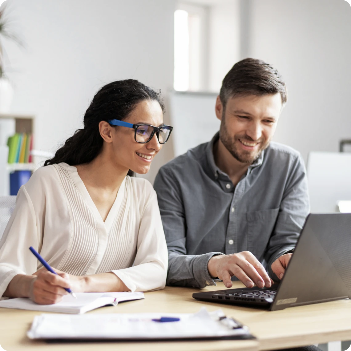 Two professionals working together at desk