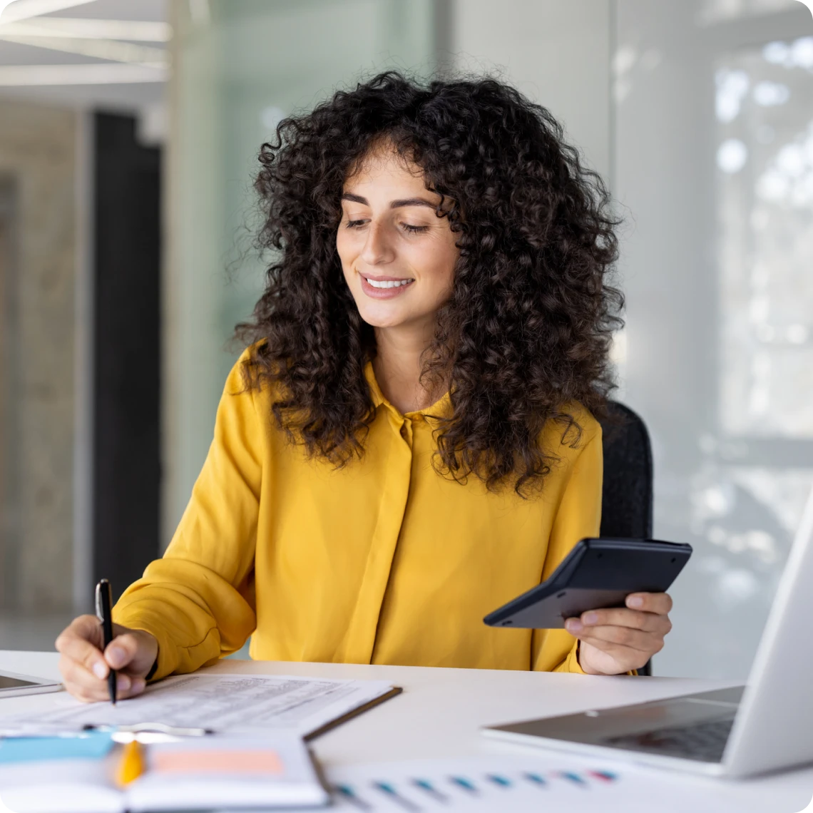 Businesswoman multitasking with tablet and papers